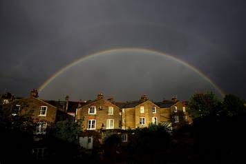 A double rainbow is seen above a row of terrace houses in Clapham, south London