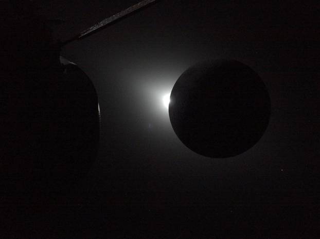 The Sun begins to emerge from behind the Moon as photographed by one of the cameras on the Orion spacecraft's solar arrays