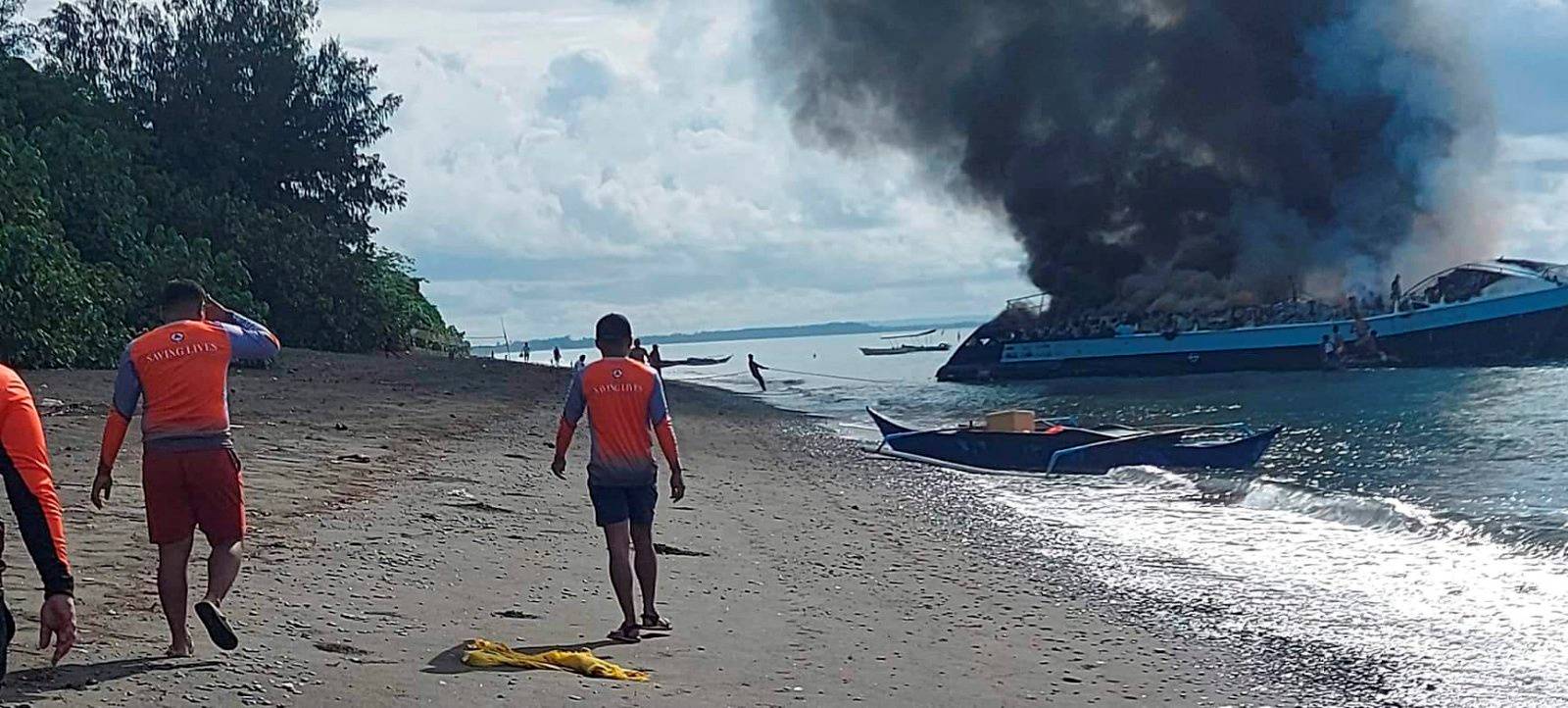 Smoke rises from a burning passenger vessel near Real