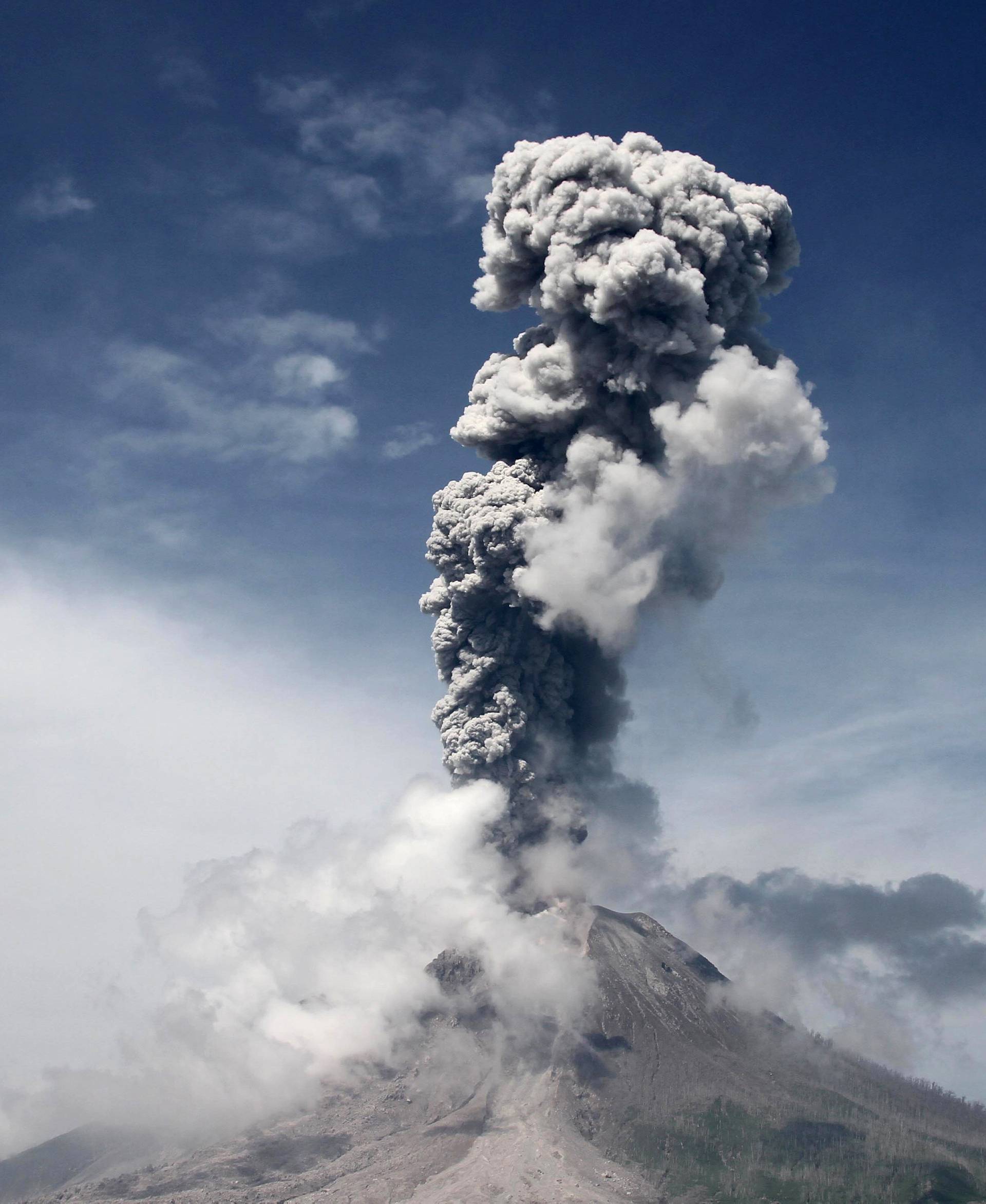Mount Sinabung volcano, active since 2010, spews smoke and ash into the air during an eruption as seen from Sukandebi village, Karo, North Sumatra
