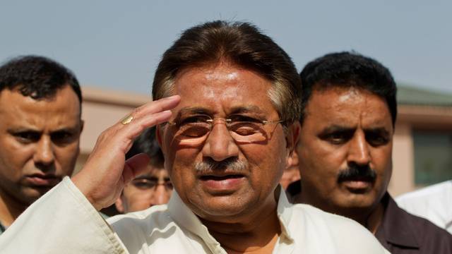 FILE PHOTO: Pakistan's former President Musharraf salutes as he arrives to unveil his party manifesto for the forthcoming general election at his residence in Islamabad