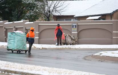 Garbage collectors work as it snows in Brackenhurst