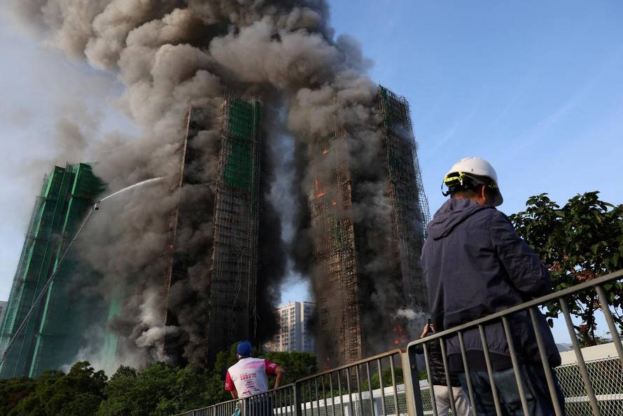 Flames engulf bamboo scaffolding across multiple buildings at Wang Fuk Court housing estate, in Tai Po