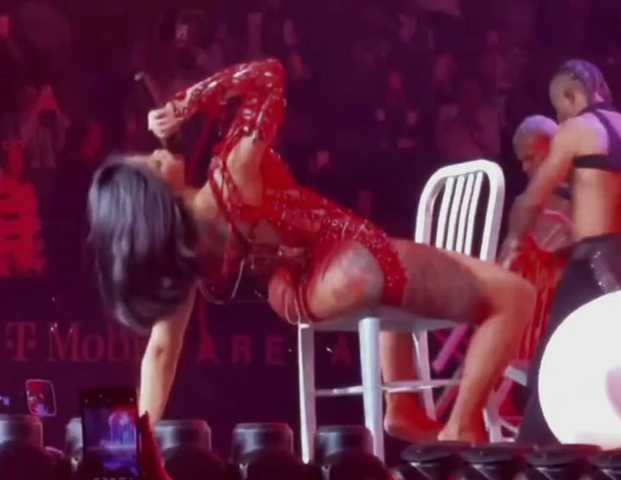 Cardi B laughs as she falls backwards out of a chair during strip dance during  Valentines Day Weekend concert in Las Vegas
