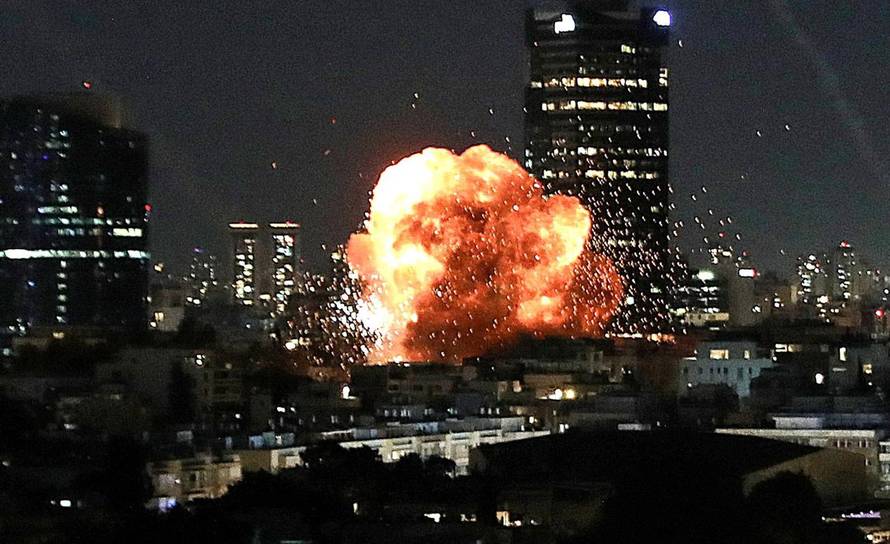 An explosion caused by a projectile impact after Iran launched missiles into Israel following Israel and the U.S. launched strikes on Iran, in Tel Aviv