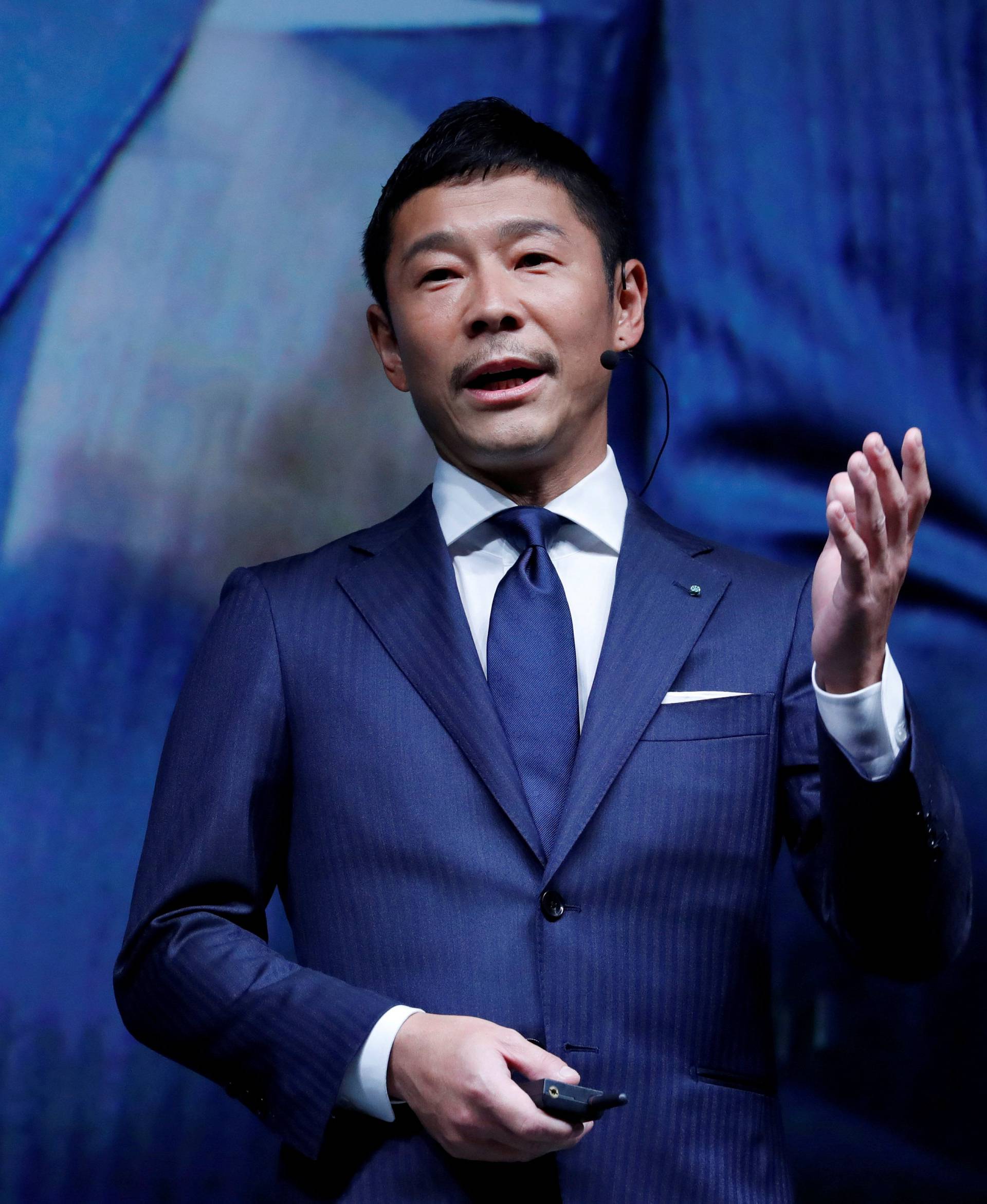 FILE PHOTO: Maezawa, the chief executive of Zozo, which operates Japan's popular fashion shopping site Zozotown and is officially called Start Today Co, speaks at an event launching the debut of its formal apparel items, in Tokyo