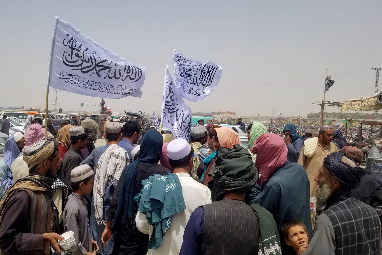 People with Taliban's flags gather to welcome a man, who was released from Prison in Afghanistan, at the Friendship Gate crossing point at the Pakistan-Afghanistan border town of Chaman