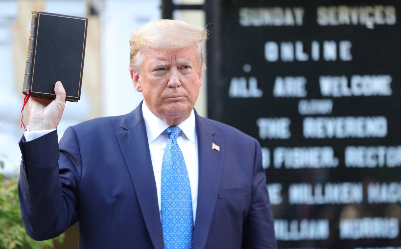 U.S. President Trump holds up Bible during photo opp in front of St John's Church in Washington