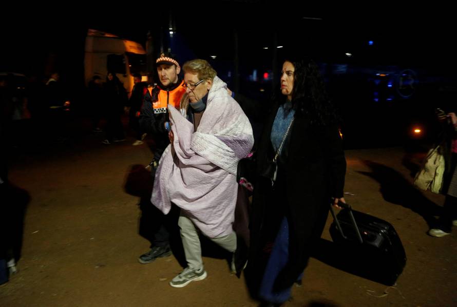 People affected by a deadly train derailment are transferred and treated at the Caseta Municipal in the town of Adamuz