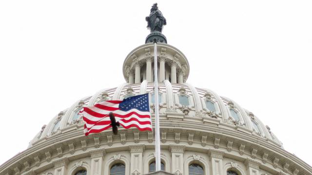 FILE PHOTO: The U.S. flag flies over the U.S. Capitol in Washington