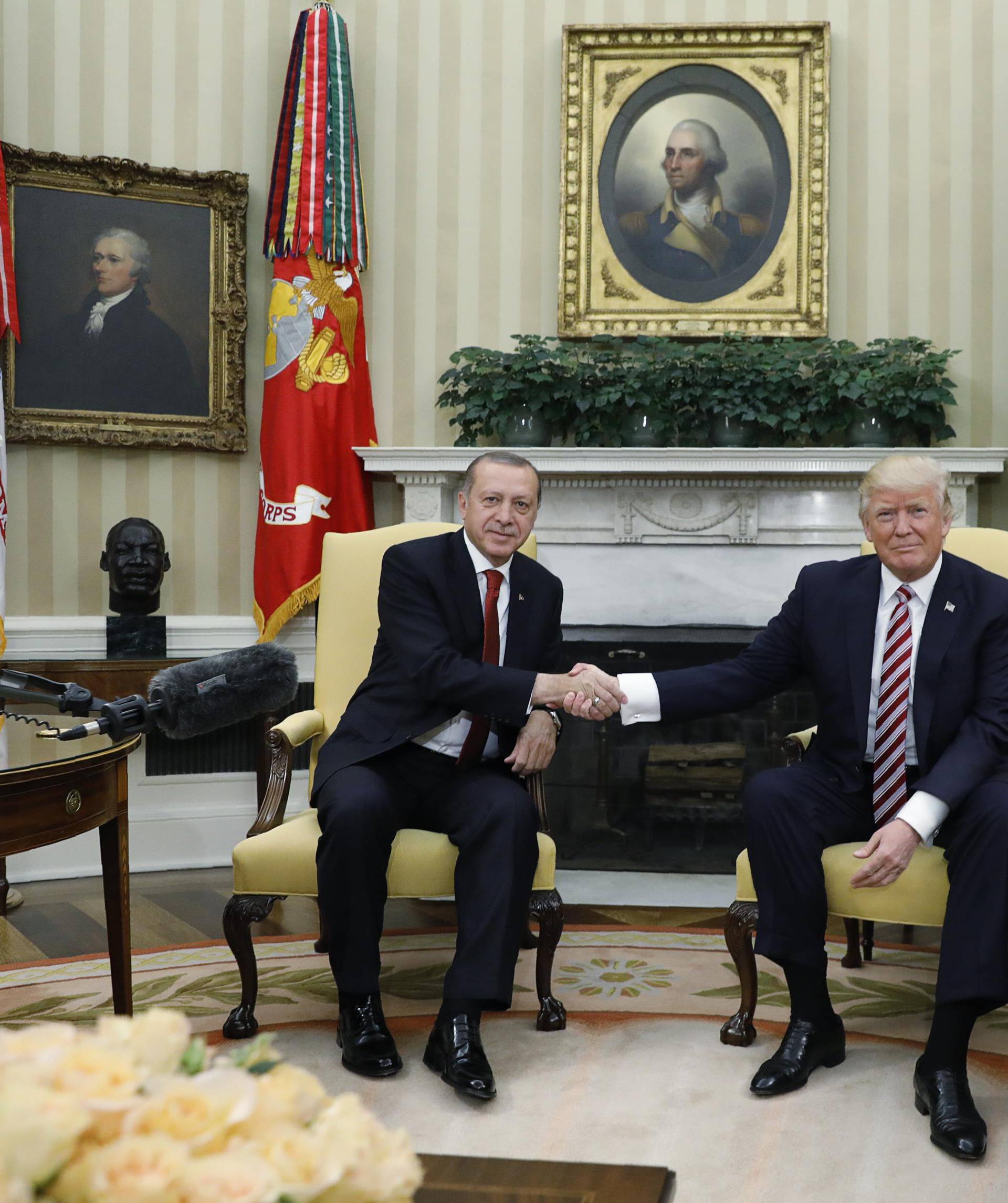 Turkey's President Erdogan shakes hands with U.S. President Trump in the Oval Office of the White House in Washington