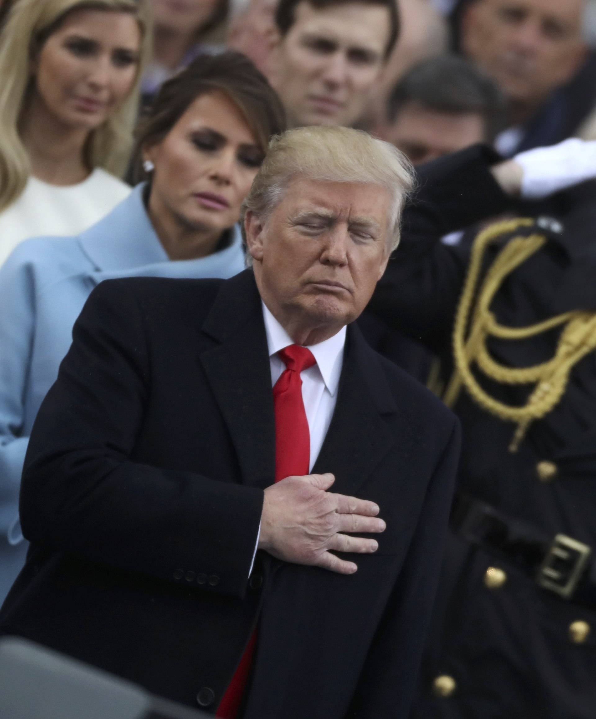 U.S. President Donald Trump and his wife Melania stand for the singing of the U.S. National Anthem during Donald Trump's inauguration ceremony at the U.S. Capitol in Washington
