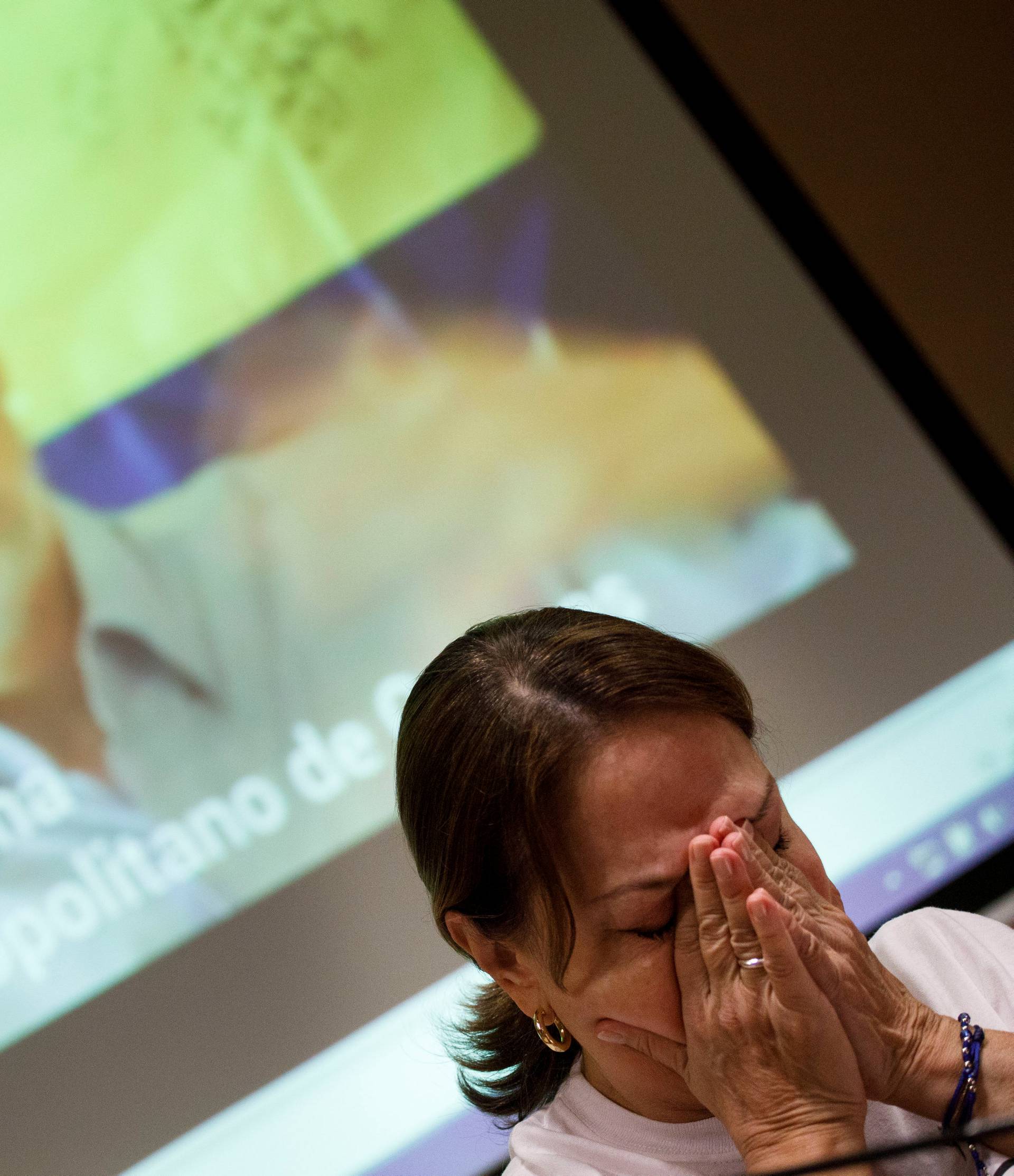 Mitzy Capriles de Ledezma, wife of former Caracas mayor Antonio Ledezma, reacts during a video showing her husband during a news conference in Madrid