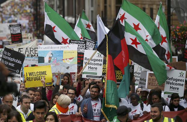 Demonstrators including refugees march to the Houses of Parliament during a protest in support of refugees, in London