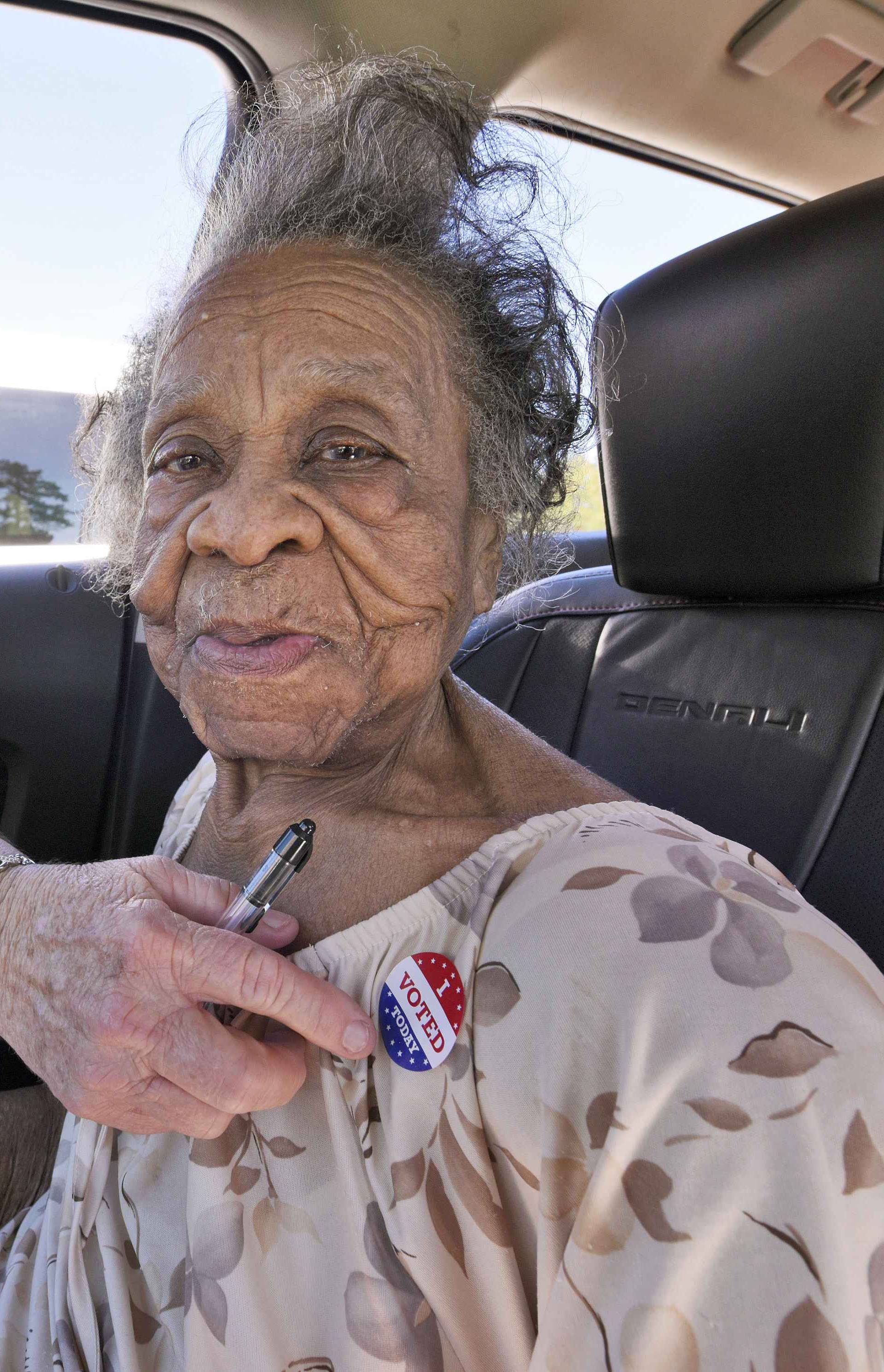 100 year old Grace Bell Hardison receives an "I Voted Today" sticker from election official Elain