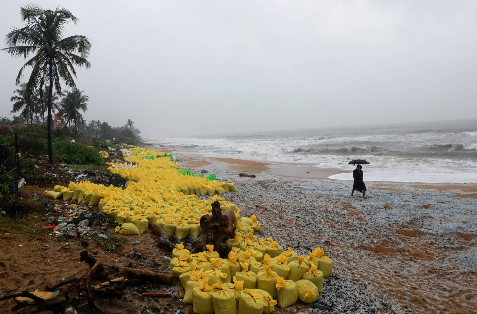 Debris from the sunken MV X-Press Pearl cargo ship are washed off to a beach in Ja-Ela