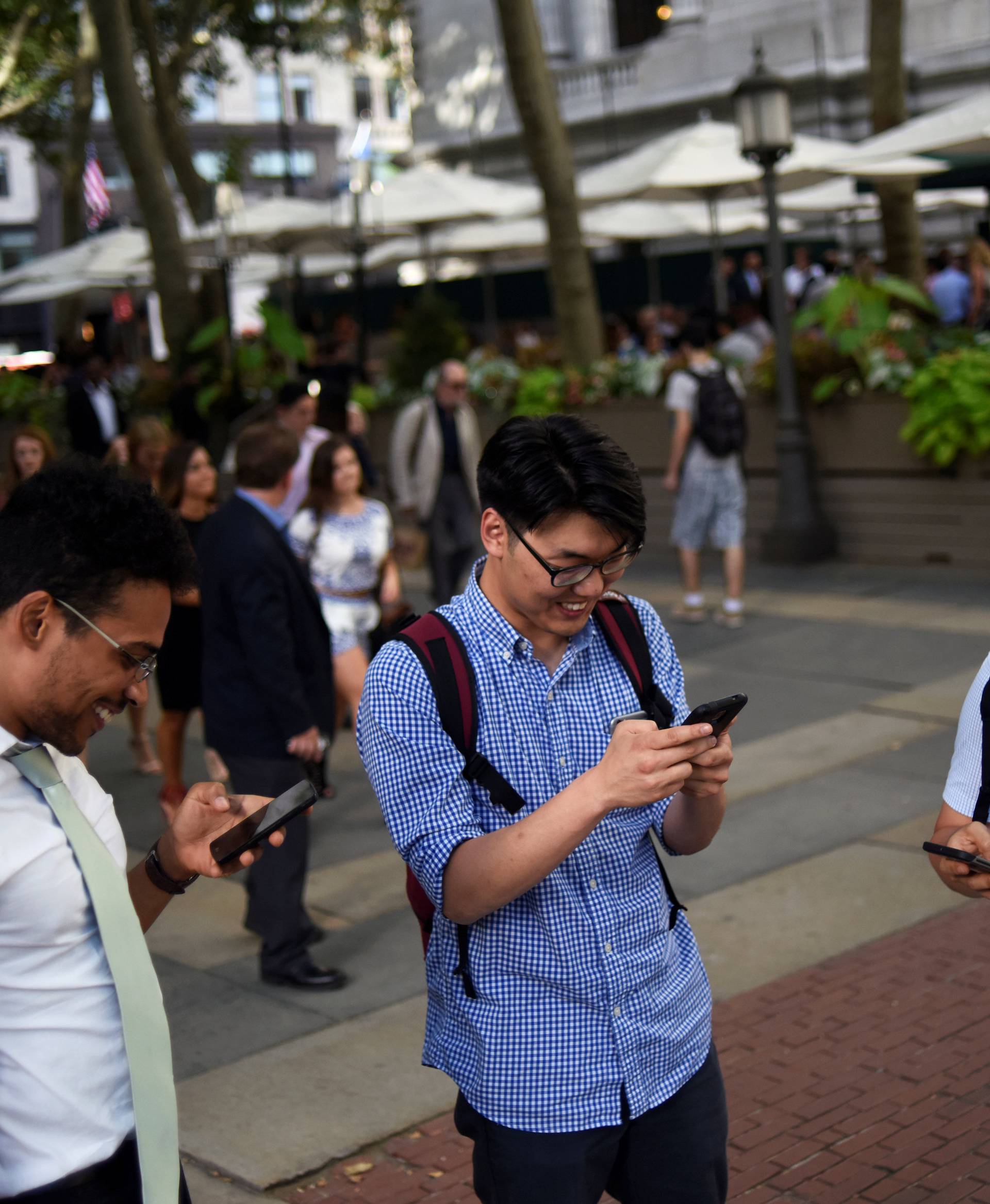 People play the augmented reality mobile game "Pokemon Go" by Nintendo in New York City