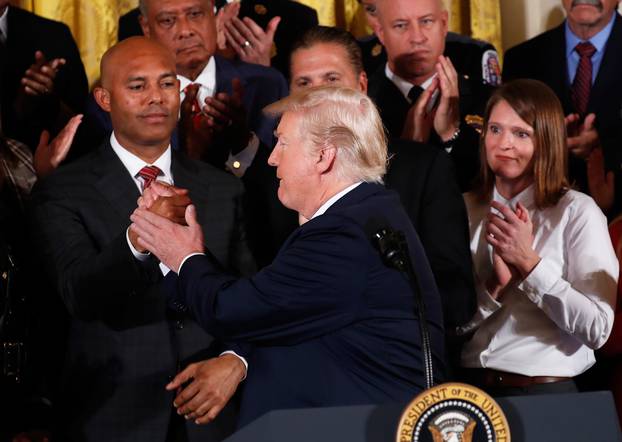 U.S. President Donald Trump greets former New York Yankees pitcher Mariano Rivera before he speaks about administration plans to combat the nation