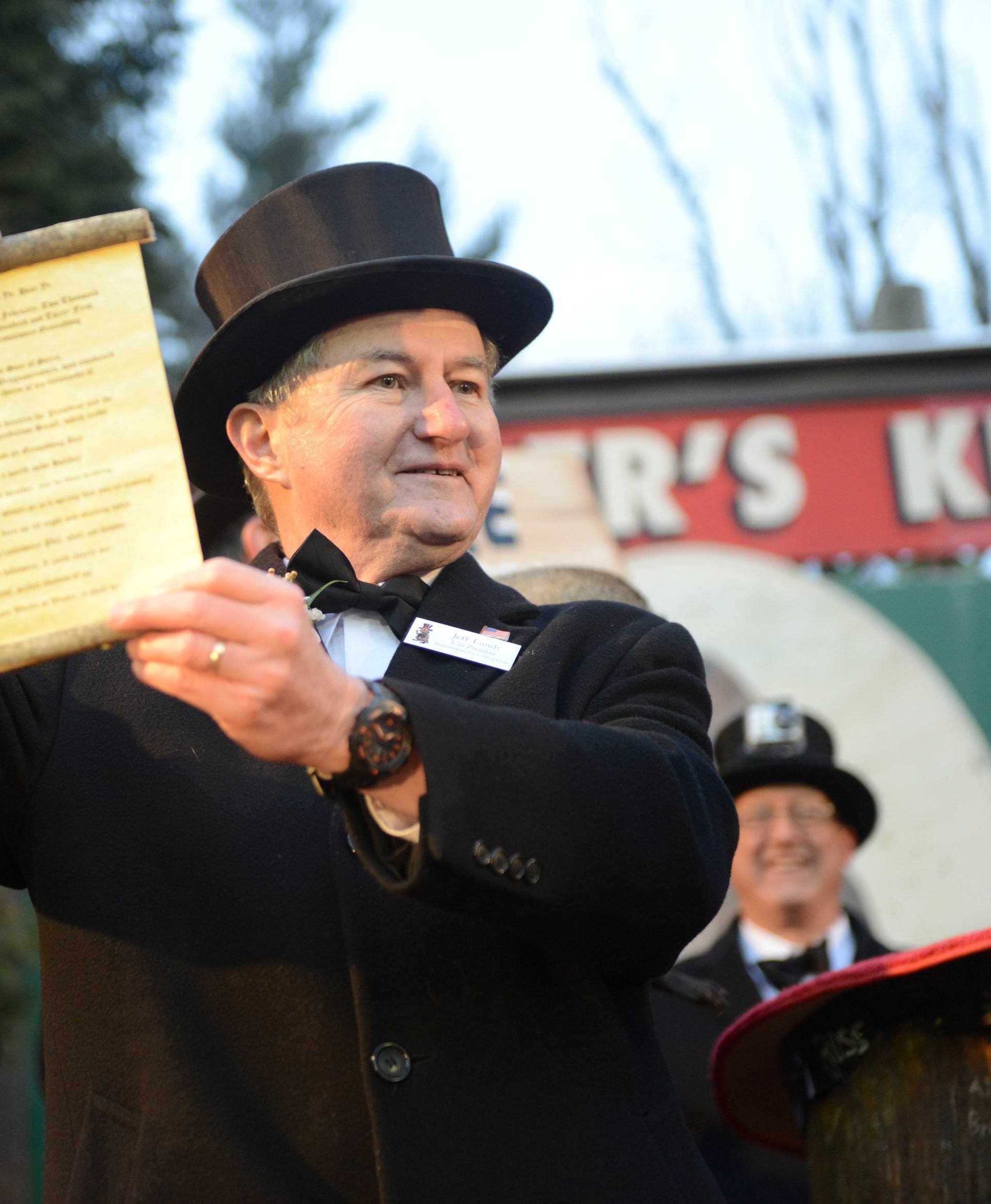 Inner Circle member Jeff Lundy holds a scroll with Punxsutawney Phil's forecast on Groundhog Day in Punxsutawney