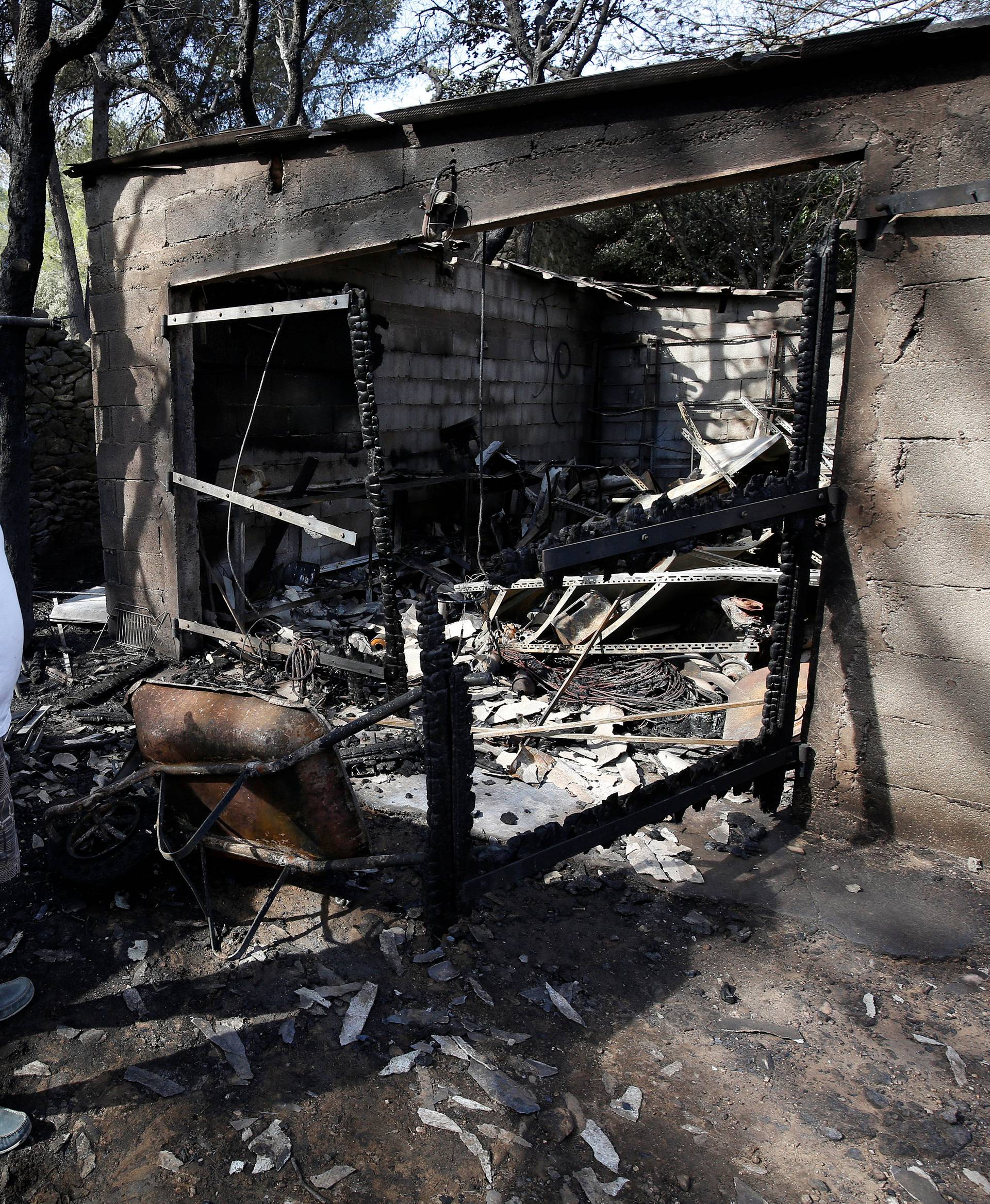 A man reacts near his destroyed home in Istres the day after fires, fanned by strong northern winds known as the mistral, ravaged more than 2,000 hectares of the dry, pine-planted hills north of Marseille