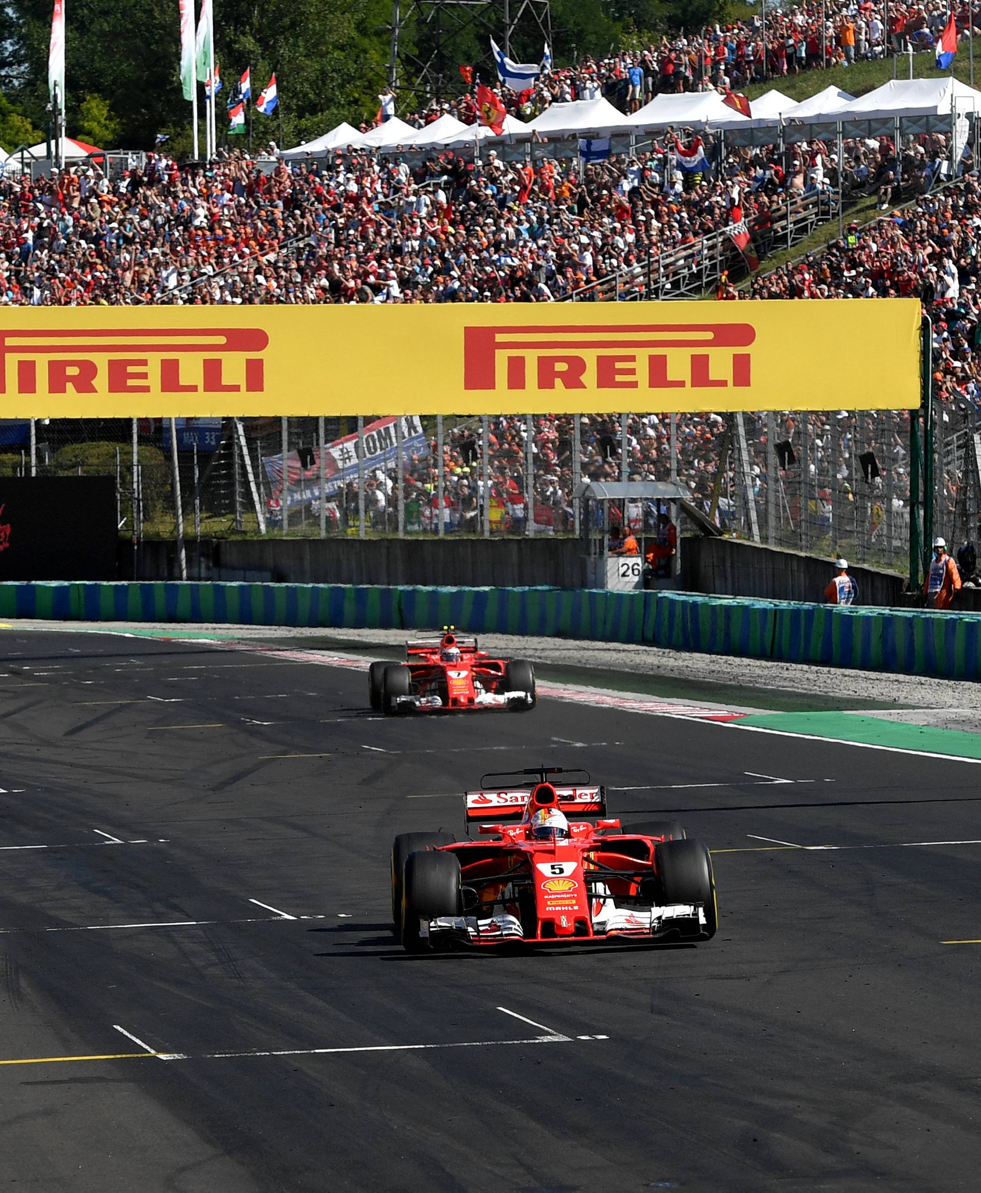 Ferrari's German driver Sebastian Vettel drives over the finish line during the Formula One Hungarian Grand Prix at the Hungaroring racing circuit in Budapest