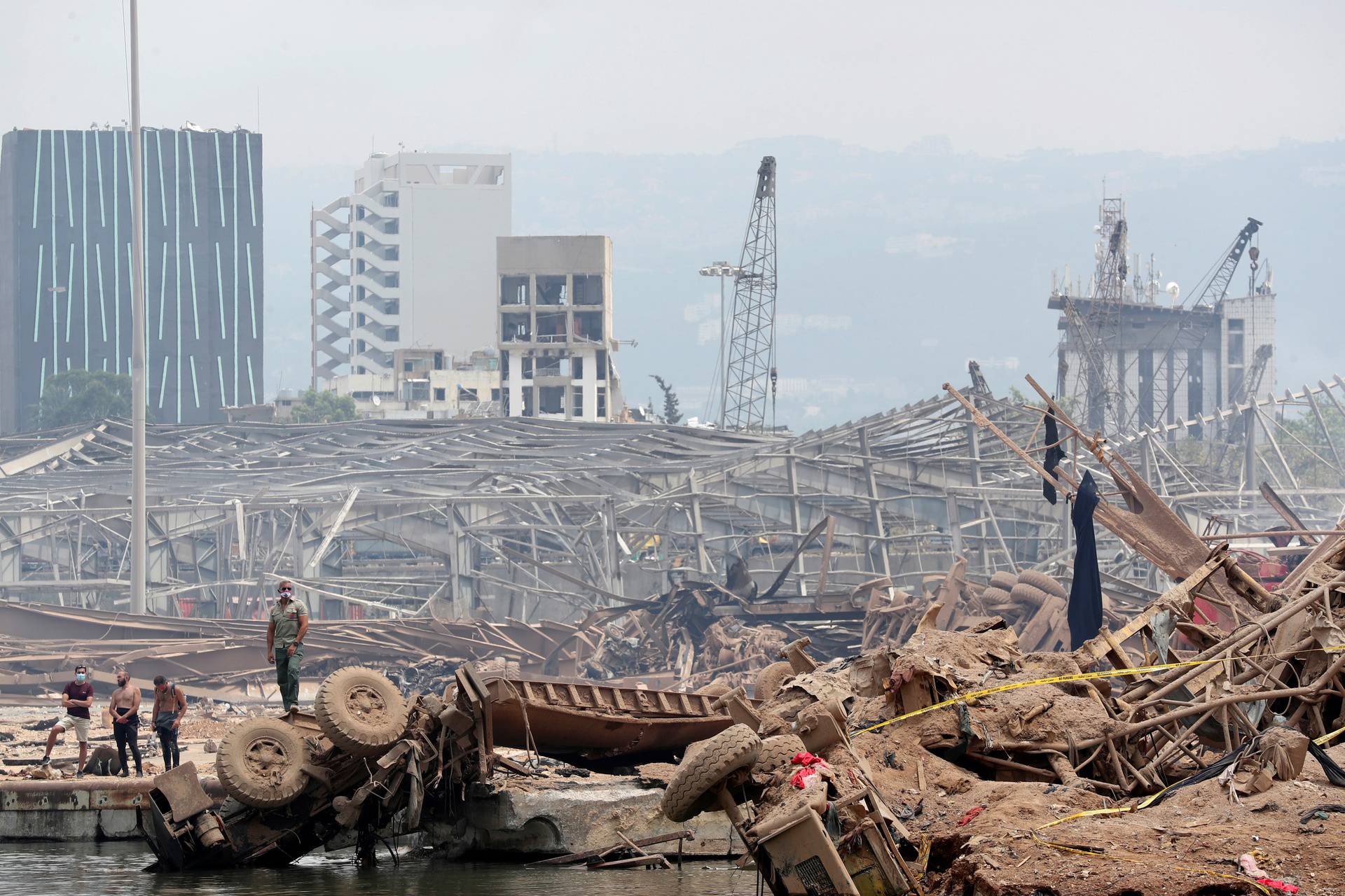 People are pictured at the devastated site of the explosion at the port of Beirut