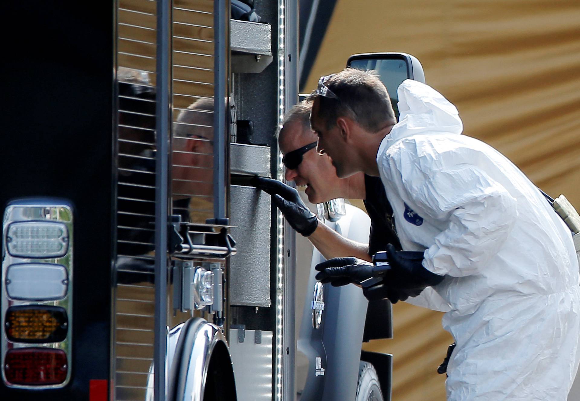 Police forensic investigators work at the crime scene of a mass shooting at the Pulse gay night club in Orlando