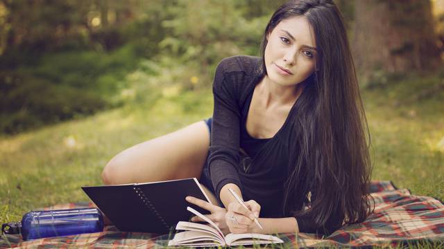 beautiful woman writer is inspired by nature