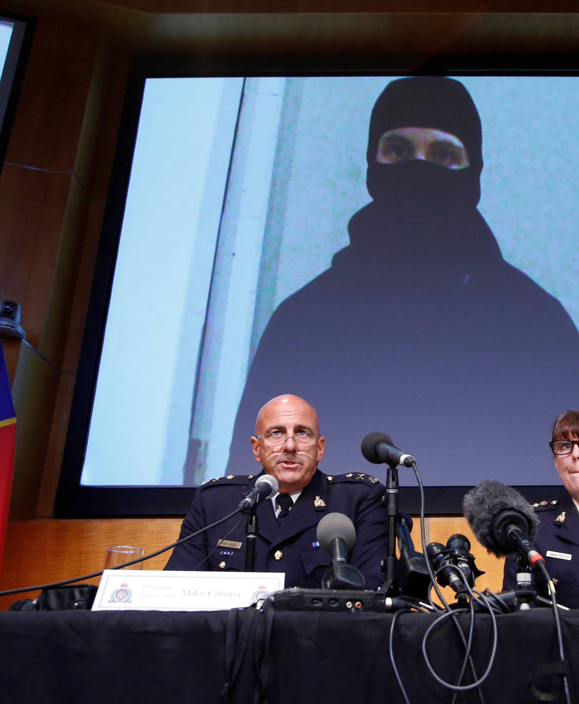 An image of Aaron Driver is projected on a screen during a news conference in Ottawa