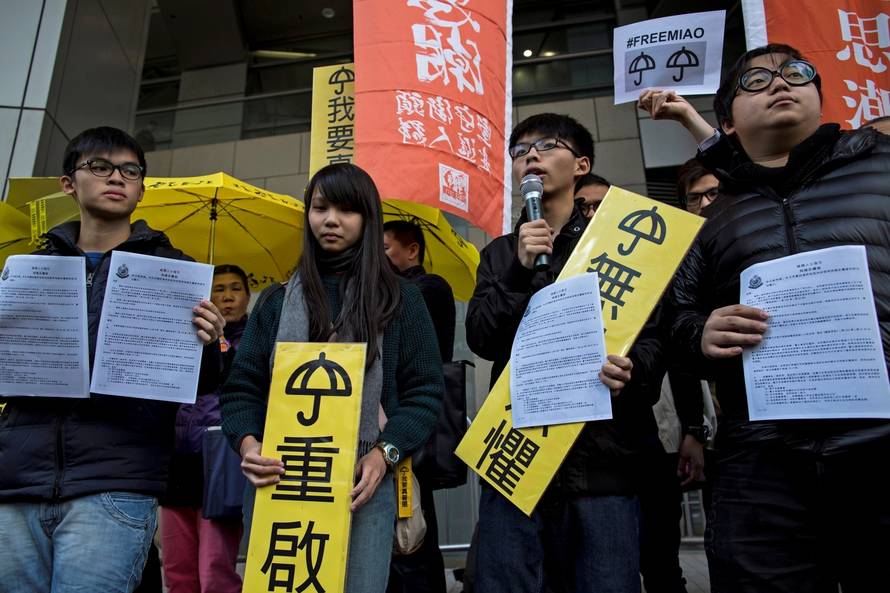 FILE PHOTO: Hong Kong student leaders Oscar Lai, Agnes Chow, Joshua Wong and Derek Lam speak as they arrive at the police headquarters in Hong Kong