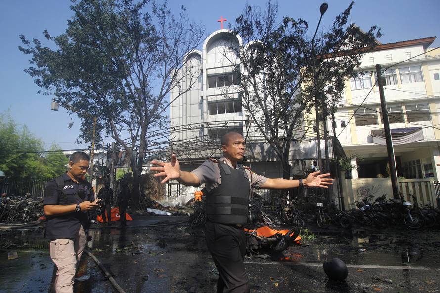 Police stand guard near the site of a blast at the Pentecost Church Central Surabaya (GPPS), in Surabaya, East Java,