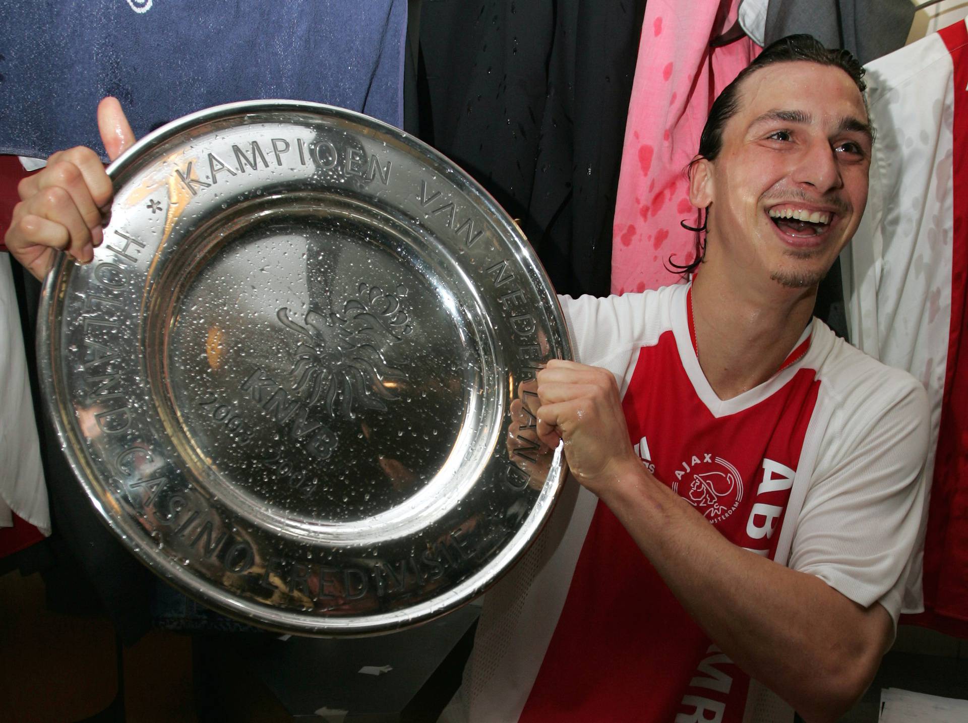 FILE PHOTO: Ajax striker Zlatan Ibrahimovic holds the Dutch Eredivisie trophy after a 2-0 victory against NAC Breda in Amsterdam.