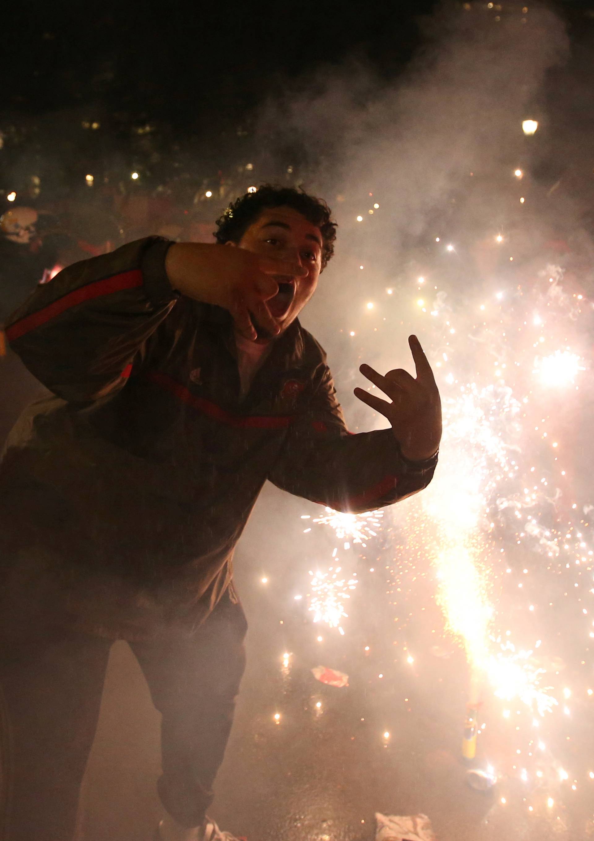 Fans light flares as they celebrate their win in Game 6 of the NBA basketball Finals between the Toronto Raptors and the Golden State Warriors on a large screen in a fan zone in Montreal