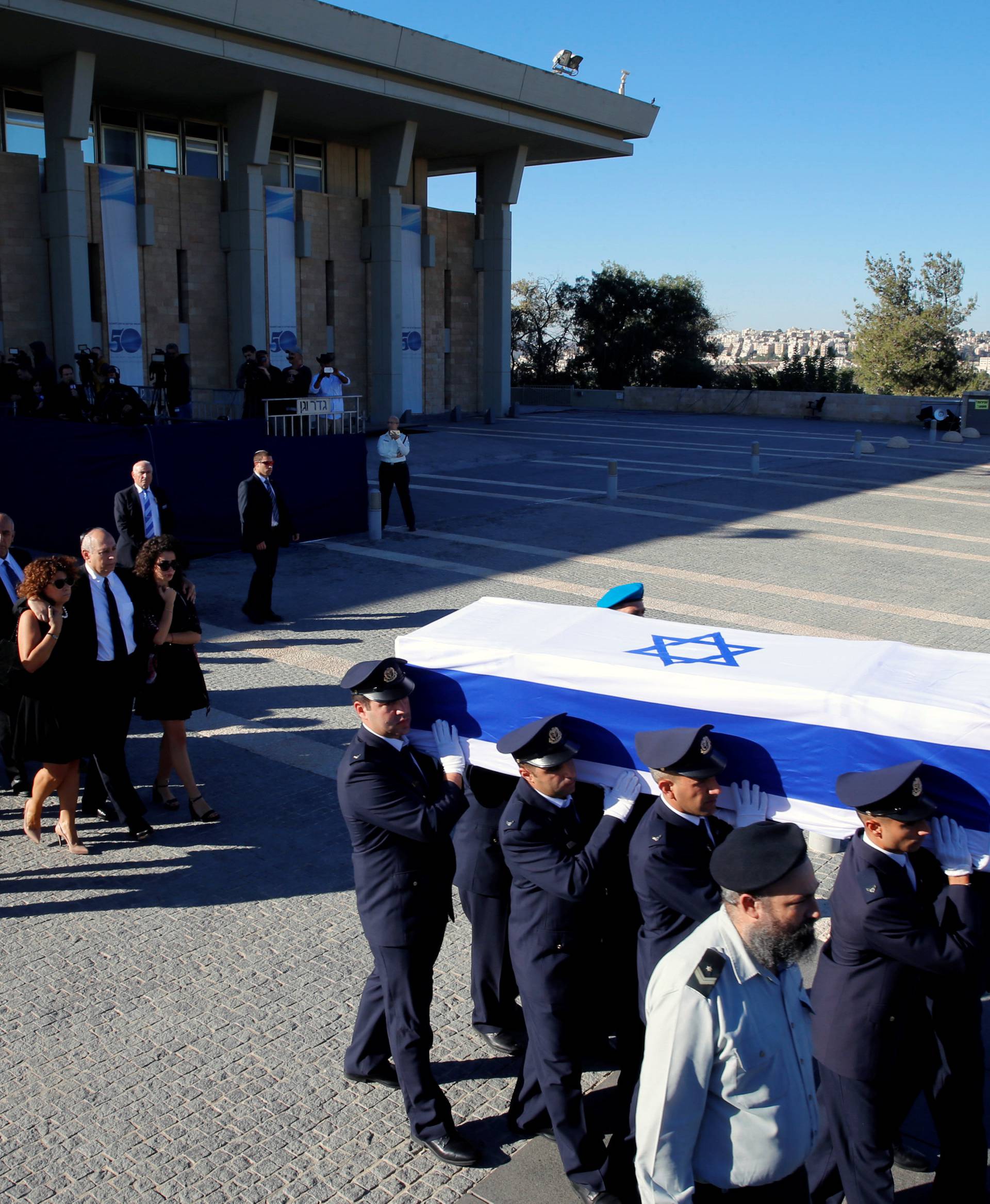 Family members of former Israeli President Shimon Peres walk behind his flag-draped coffin during a ceremony at the Knesset, the Israeli parliament, before it is transported to Mount Herzl Cemetery ahead of the funeral in Jerusalem 