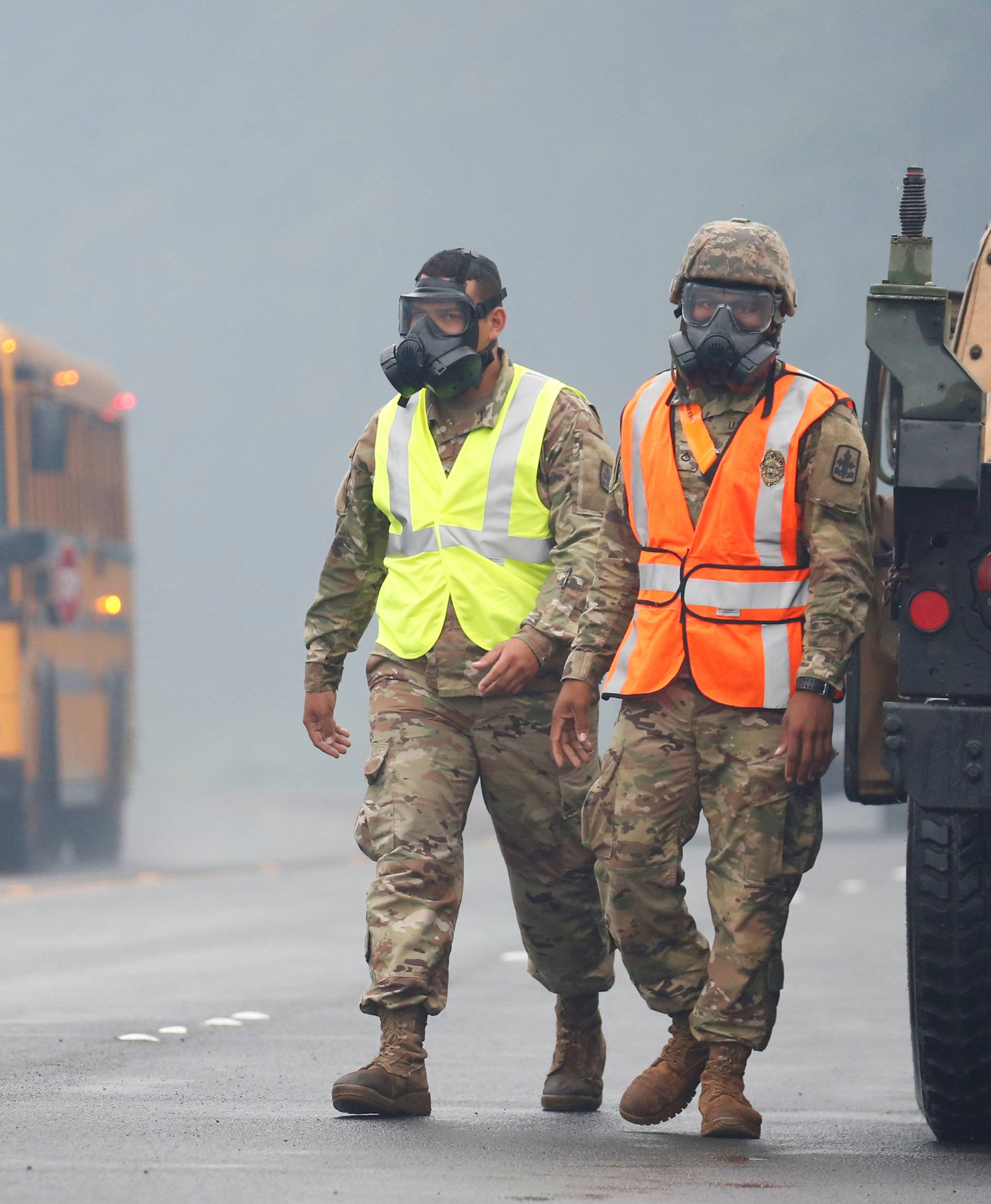 Hawaii National Guard soldiers wear masks to protect themselves from volcanic gases in Pahoa