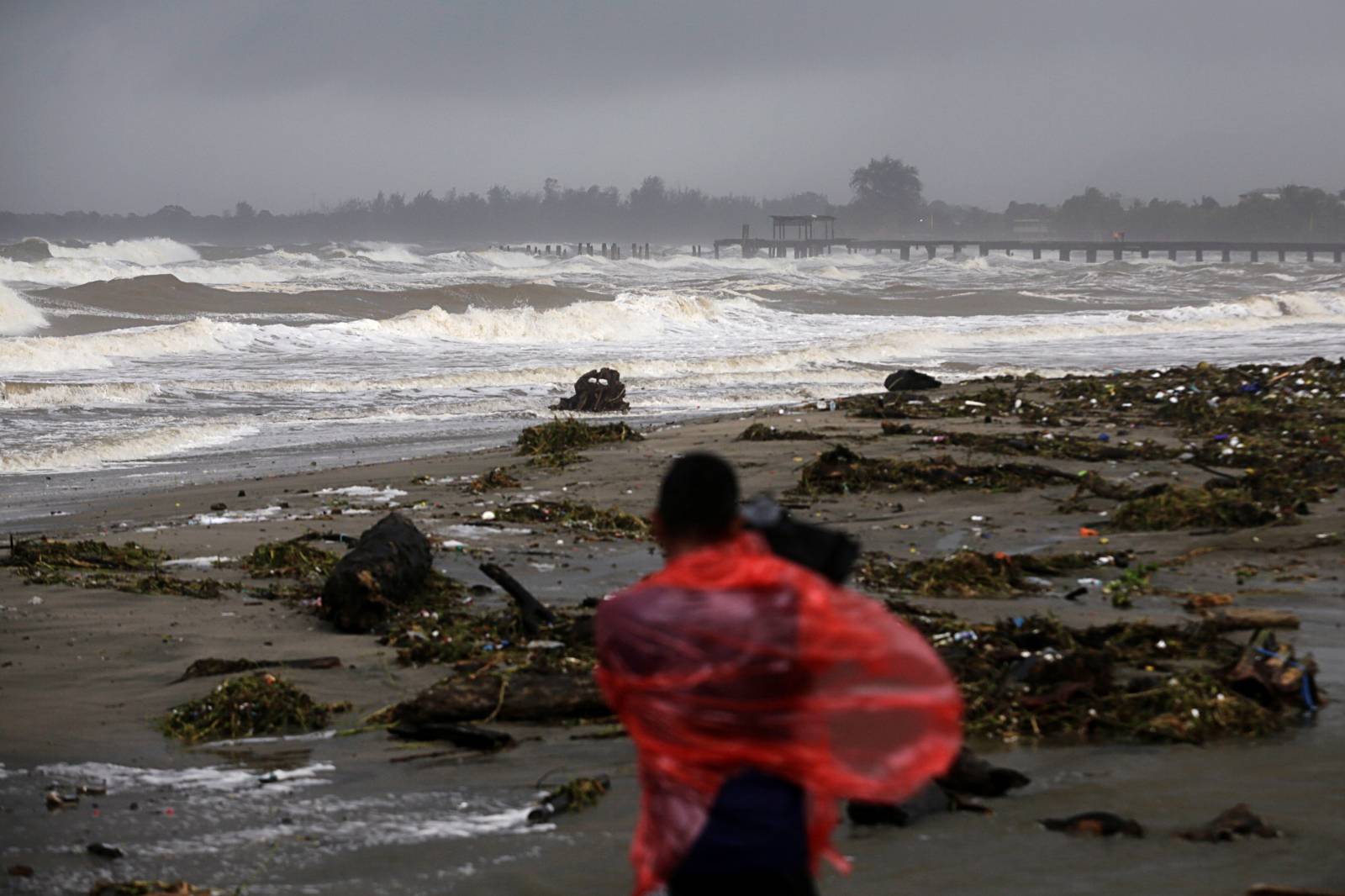 A cameraman films a beach as Hurricane Eta approaches, in Tela