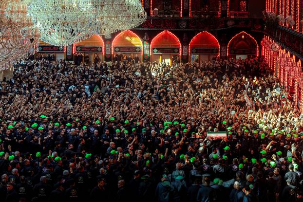 Mourners carry the coffins of family members of Iran’s late Supreme Leader Ayatollah Ali Khamenei, inside the shrine of Imam Abbas during funeral ceremonies in Karbala