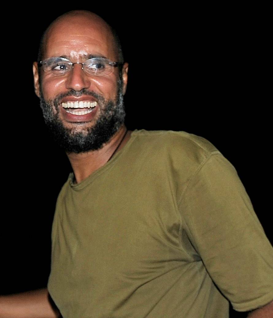 FILE PHOTO: File photo of Saif al-Islam, the son of Libyan leader Muammar Gaddafi, greeting supporters in Tripoli