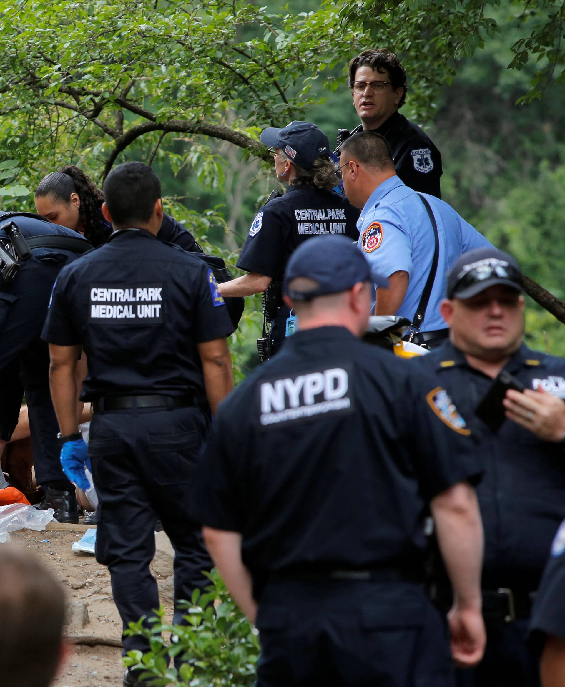 Medics treat a man who was injured after an explosion in Central Park in Manhattan, New York