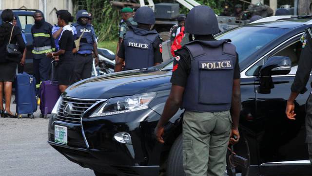 Police officers are seen conducting checks on vehicles at the Federal High court in Abuja