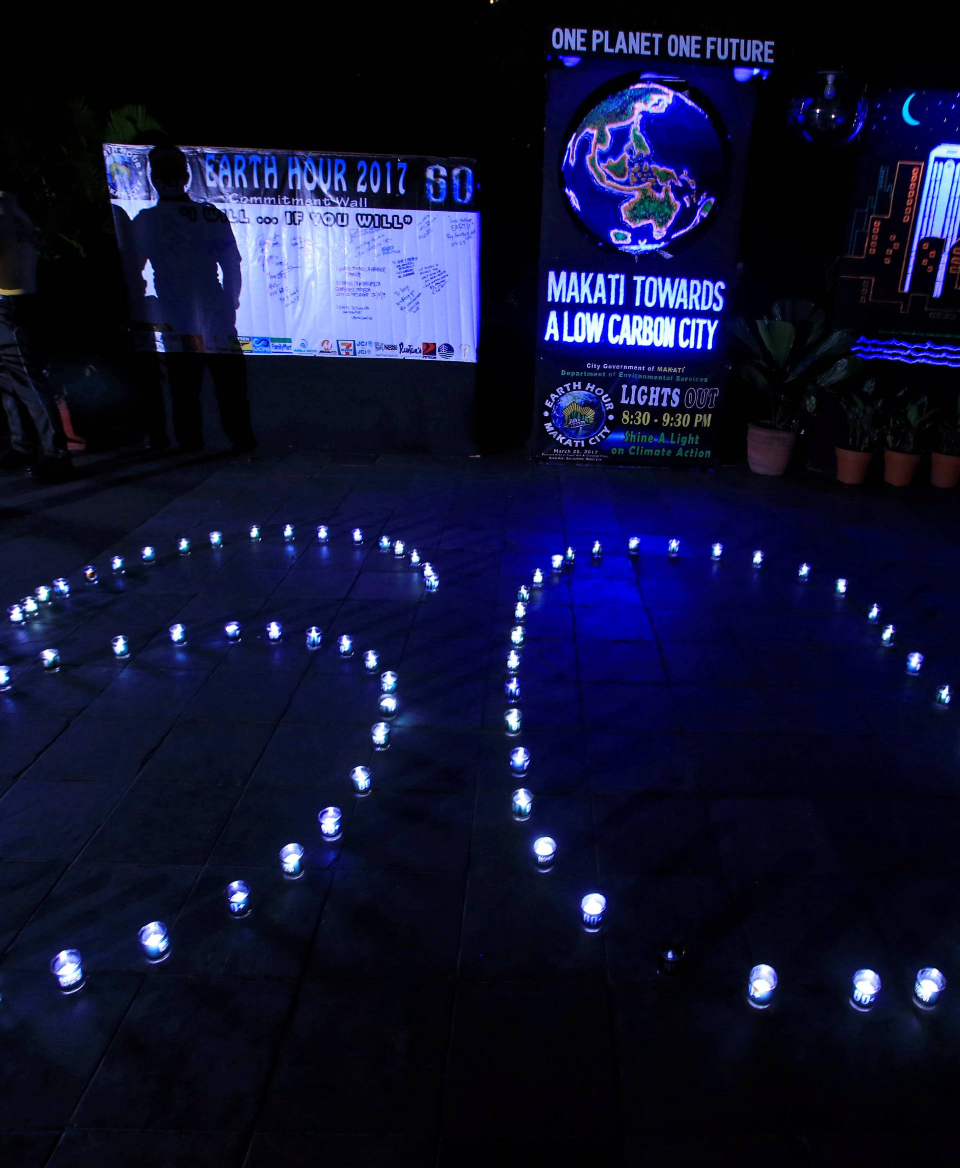 Glasses with lights lamps form the number 60, representing the 60 minutes of Earth Hour, during Earth Hour in Makati city, metro Manila