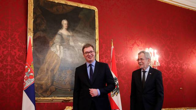 Serbia's President Vucic and Austria's President Van der Bellen walk by a portrait of former Empress Maria Theresa at the presidential office in Vienna