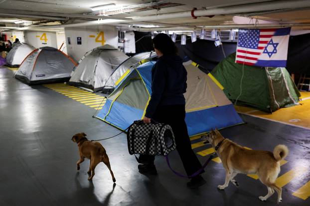 Israelis hold a Passover Seder in an underground parking garage used as a public bomb shelter, in Tel Aviv