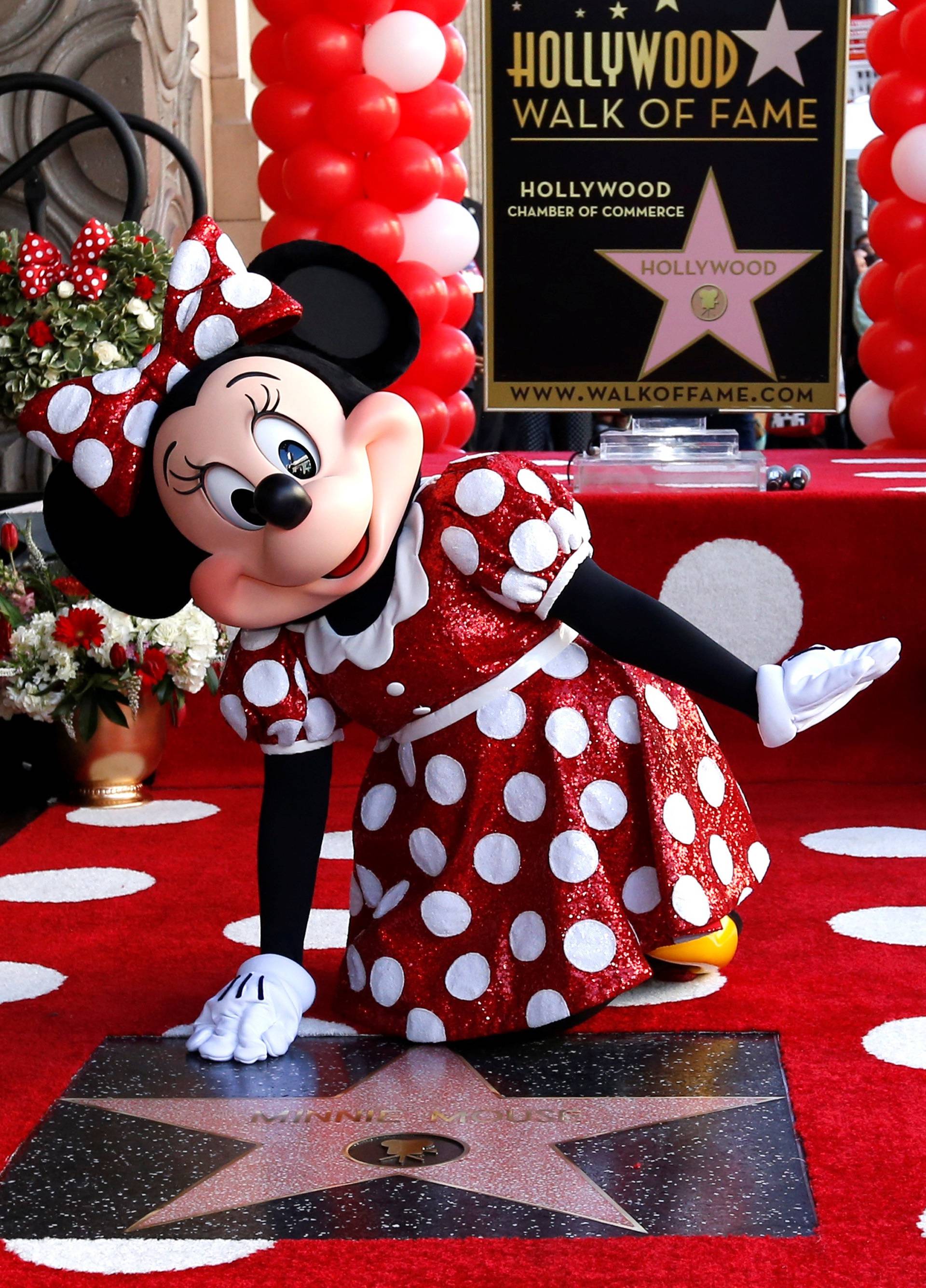 The character of Minnie Mouse poses on her star after it was unveiled on the Hollywood Walk of Fame in Los Angeles