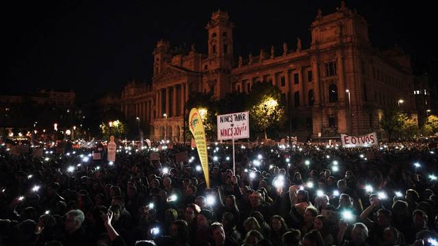 People light up their mobile phones during a protest in support of teachers fighting for higher wages and teachers sacked for protesting, in Budapest