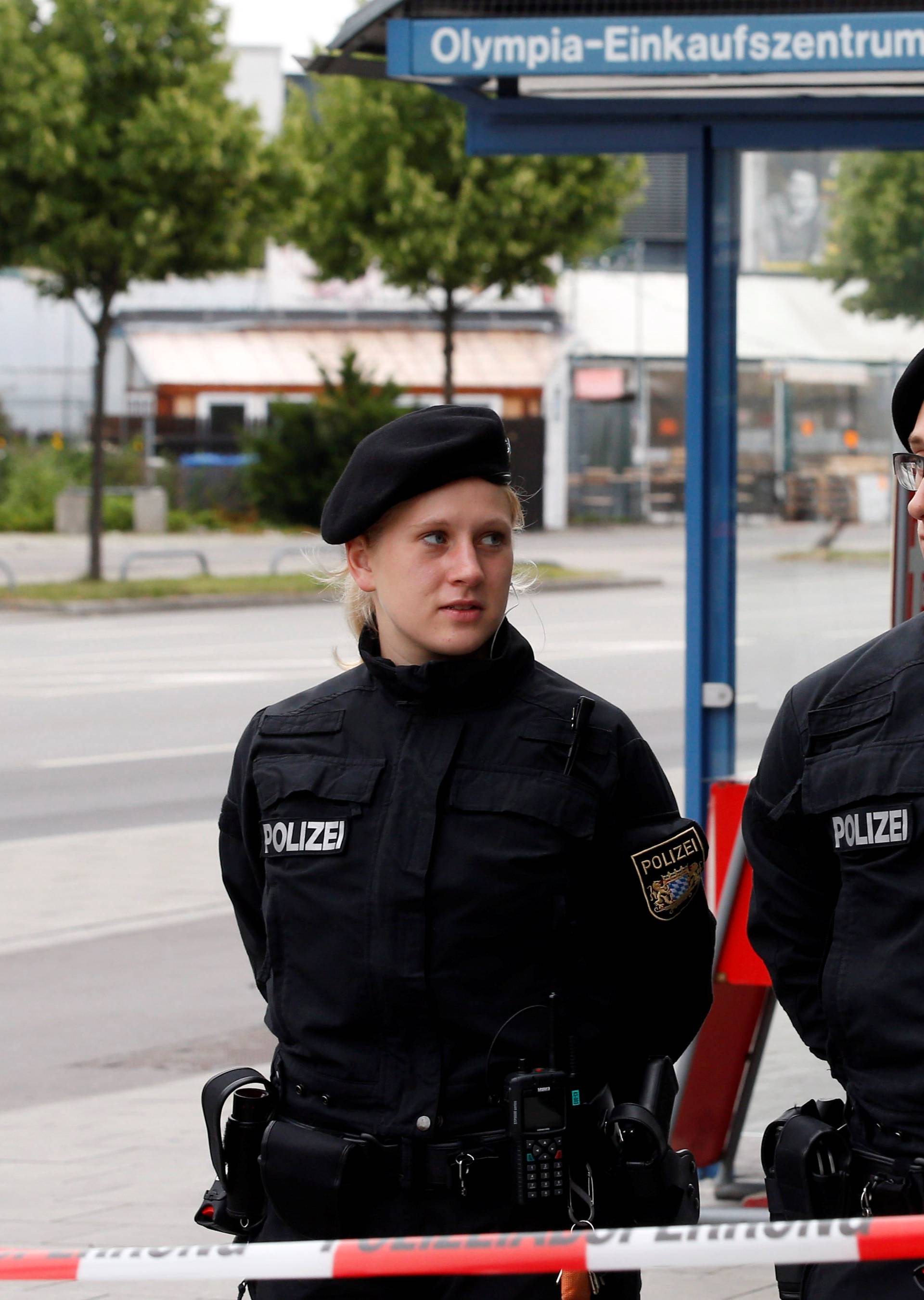 Policemen stand guard near the Olympia shopping mall, where yesterday's shooting rampage started, in Munich
