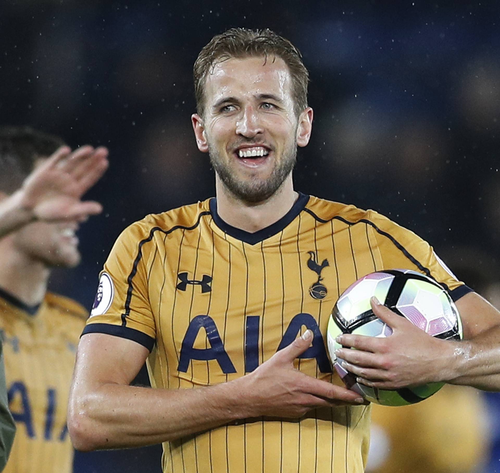 Tottenham's Harry Kane holds the match ball as he celebrates after the match