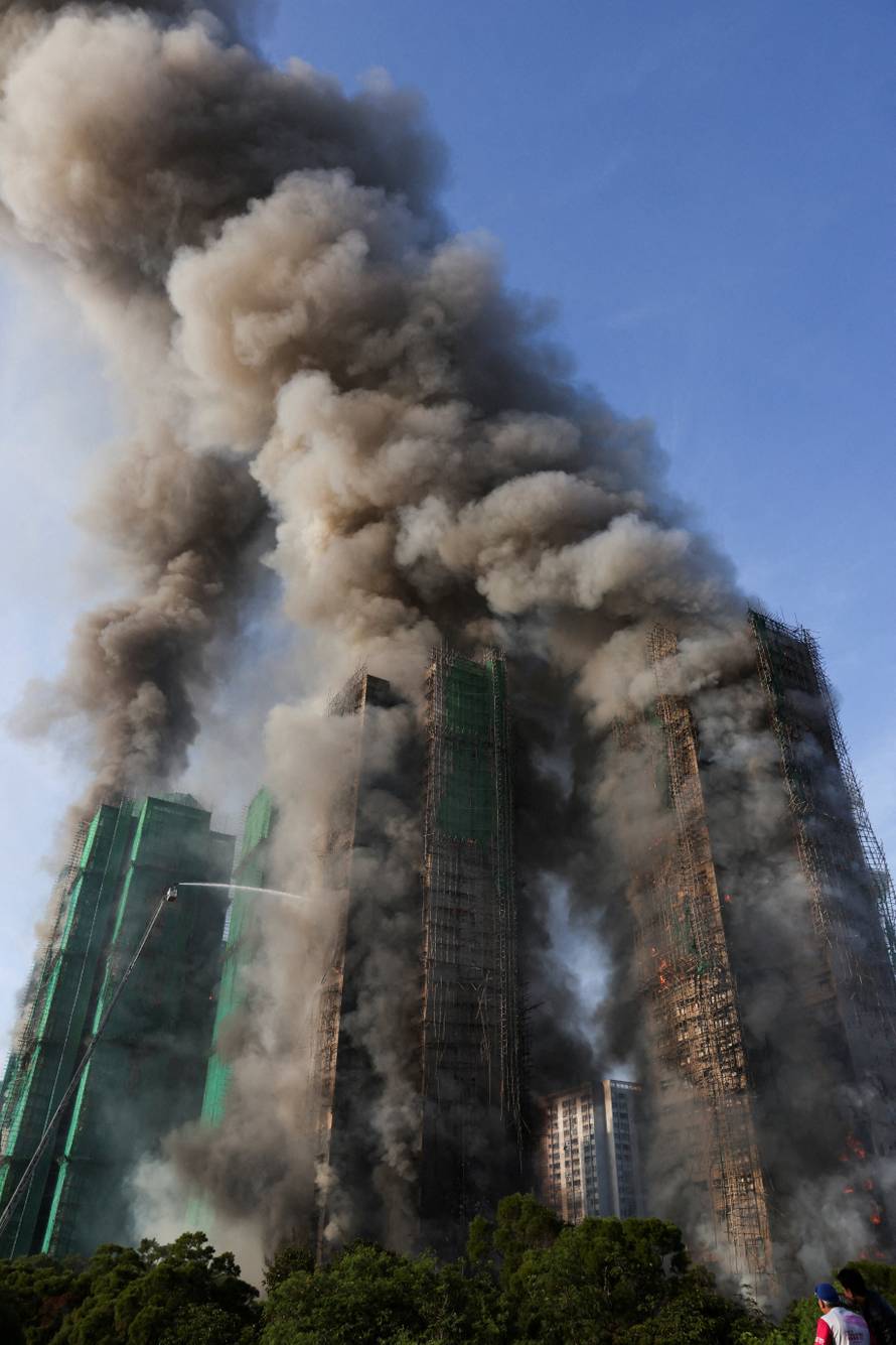 Flames engulf bamboo scaffolding across multiple buildings at Wang Fuk Court housing estate, in Tai Po