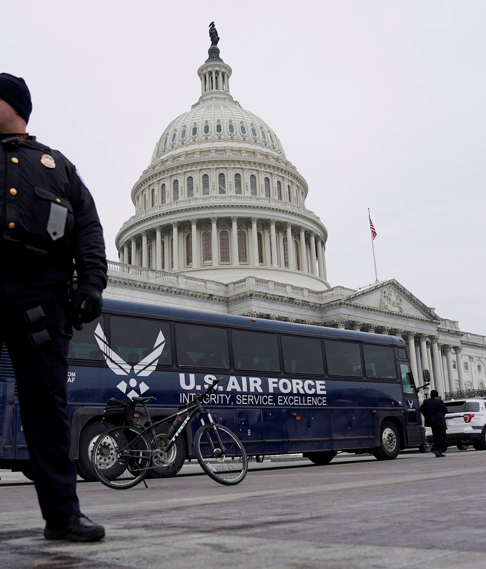 Air Force bus meant to transport Speaker of the House Pelosi and other members of Congress to flight to Afghanistan sits in front of Capitol in Washington
