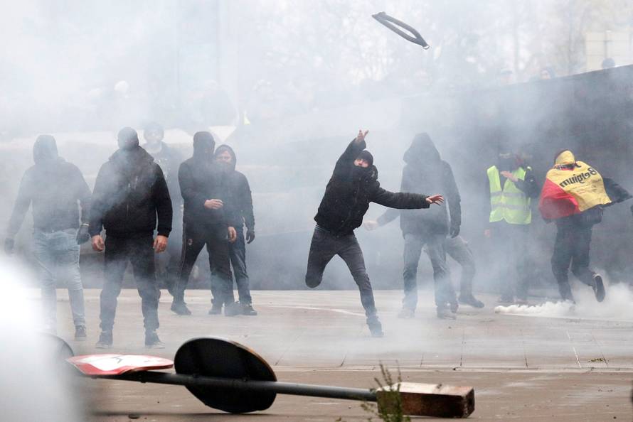 Far-right supporter throws an object during a protest against Marrakesh Migration Pact in Brussels